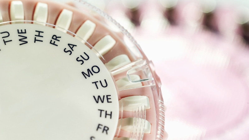 A close-up of a birth control pill pack with days marked